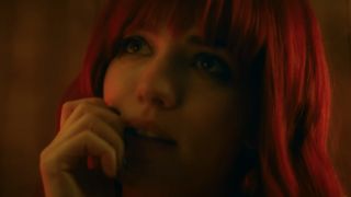 Willa Fitzgerald with red hair boasting a cheeky glance in Strange Darling