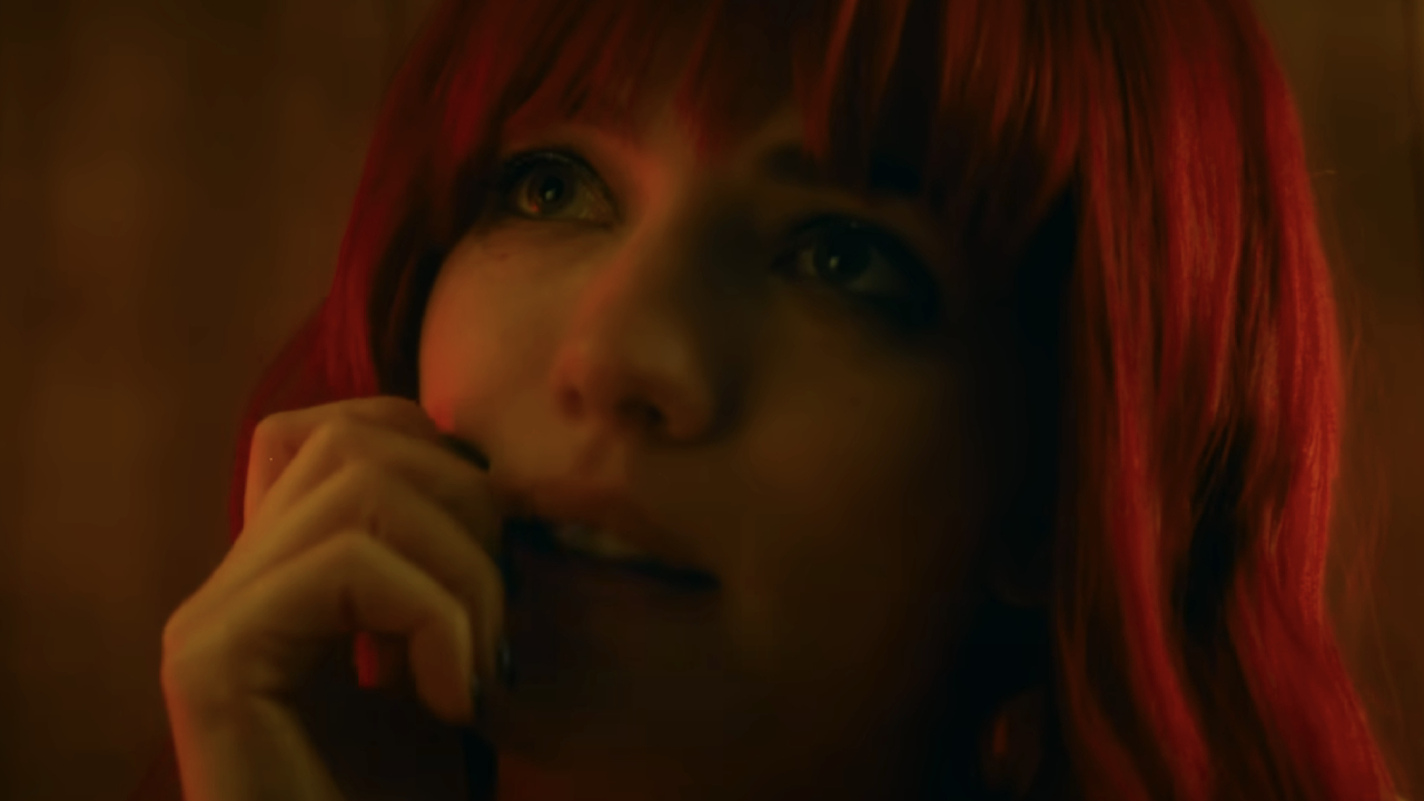 Willa Fitzgerald with red hair boasting a cheeky glance in Strange Darling