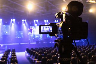 camera filming TV studio with audience