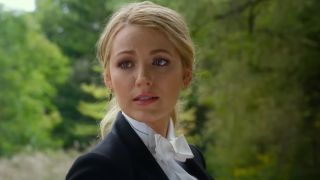 Blake Lively in A Simple Favor wearing a tux and looking over her shoulder.