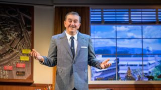 Walt Disney animatronic with hands out and palms up