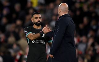 Arne Slot head coach of Liverpool with Mohamed Salah of Liverpool at the end of the Premier League match between Arsenal FC and Liverpool FC at Emirates Stadium on October 27, 2024 in London, England.