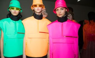 Models wear neon gilts and matching hats in green, orange and pink
