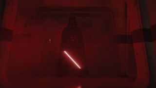 Darth Vader stands in a dark hallway with his lightsaber ignited in Rogue One: A Star Wars Story.