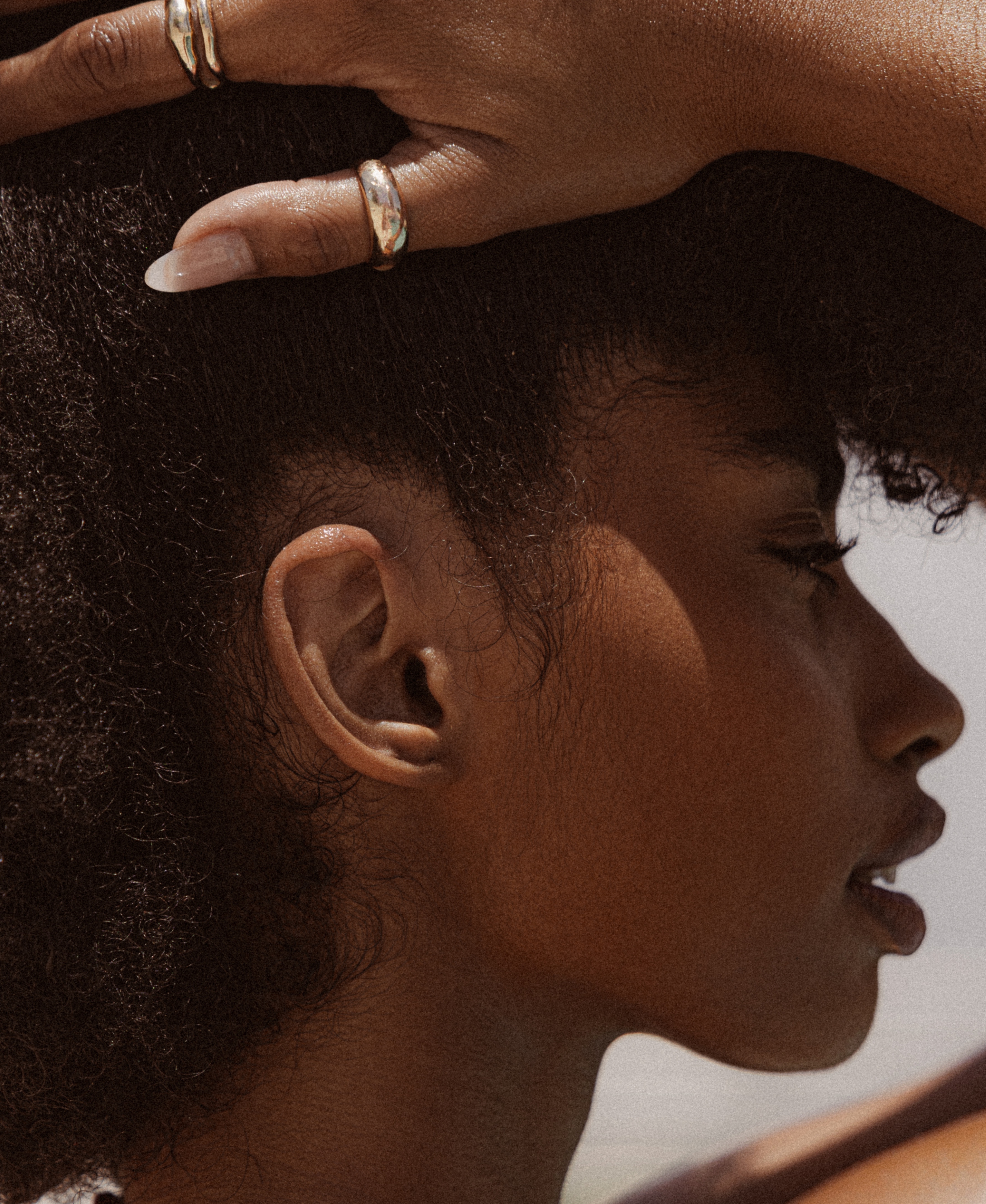 The side profile of a model with glowing skin