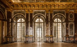 Marble walls inside chateau and arched windows