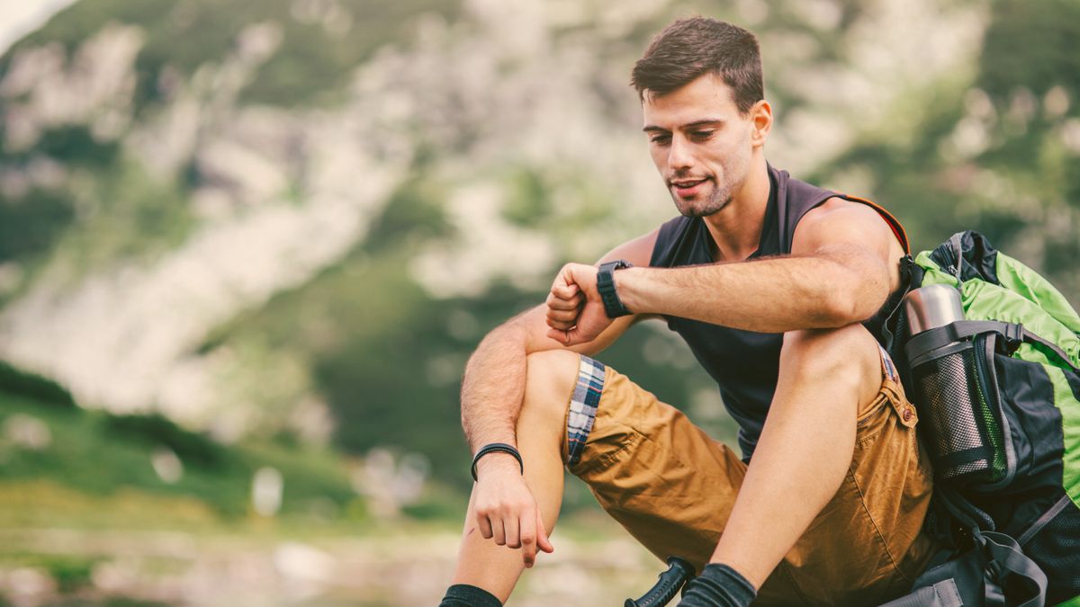 Man checking GPS watch while hiking