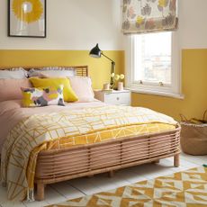 bedroom with sunshine yellow and white wall and bed