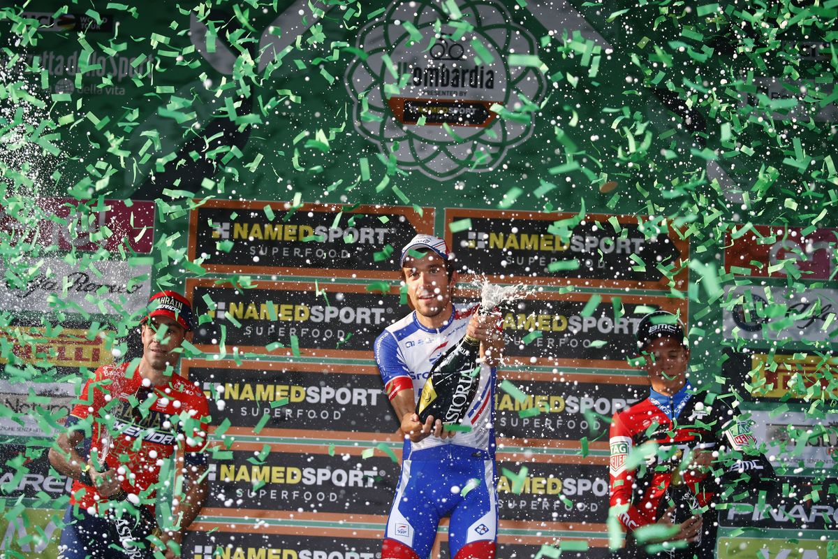 Thibaut Pinot opens the spumante on the Il Lombardia podium