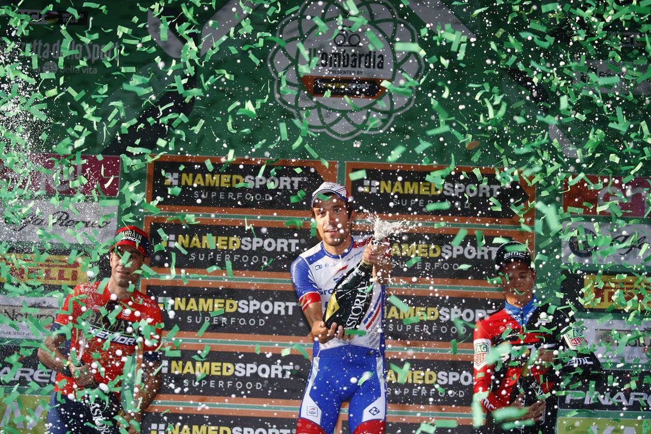 Thibaut Pinot opens the spumante on the Il Lombardia podium