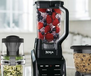 A trio of Ninja blenders on a kitchen counter.