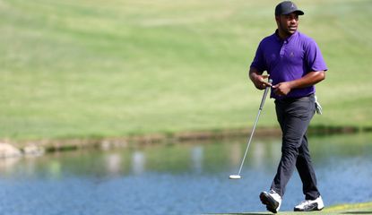 Harold Varner walks across the green