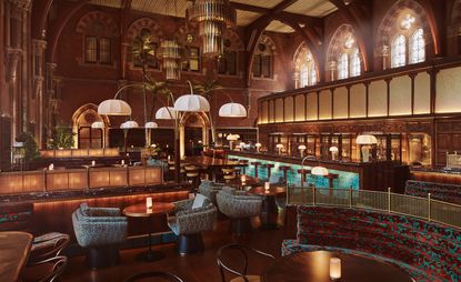 The interiors of the Booking Office 1869 featuring a large high ceiling room with various style of hanging lampshades, large oval stained windows, bar lamps, seating areas. 