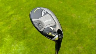 Ping G430 Hybrid held aloft to reveal its sleek looking sole