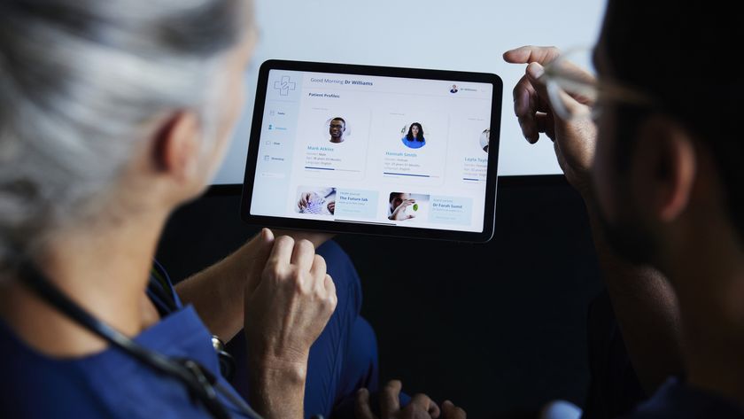 Two doctors looking at patient data on digital tablet