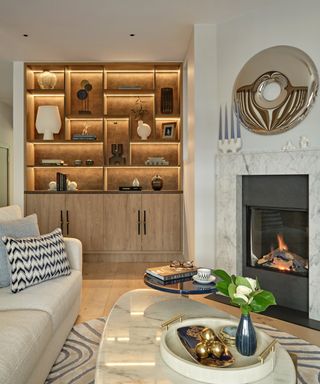 living room with backlit shelves and modern fireplace