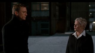 Daniel Craig and Judi Dench stand talking in the snow in Quantum of Solace.