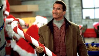 Howard Langston (Arnold Schwarznegger) holds a giant candy cane in Jingle All the Way