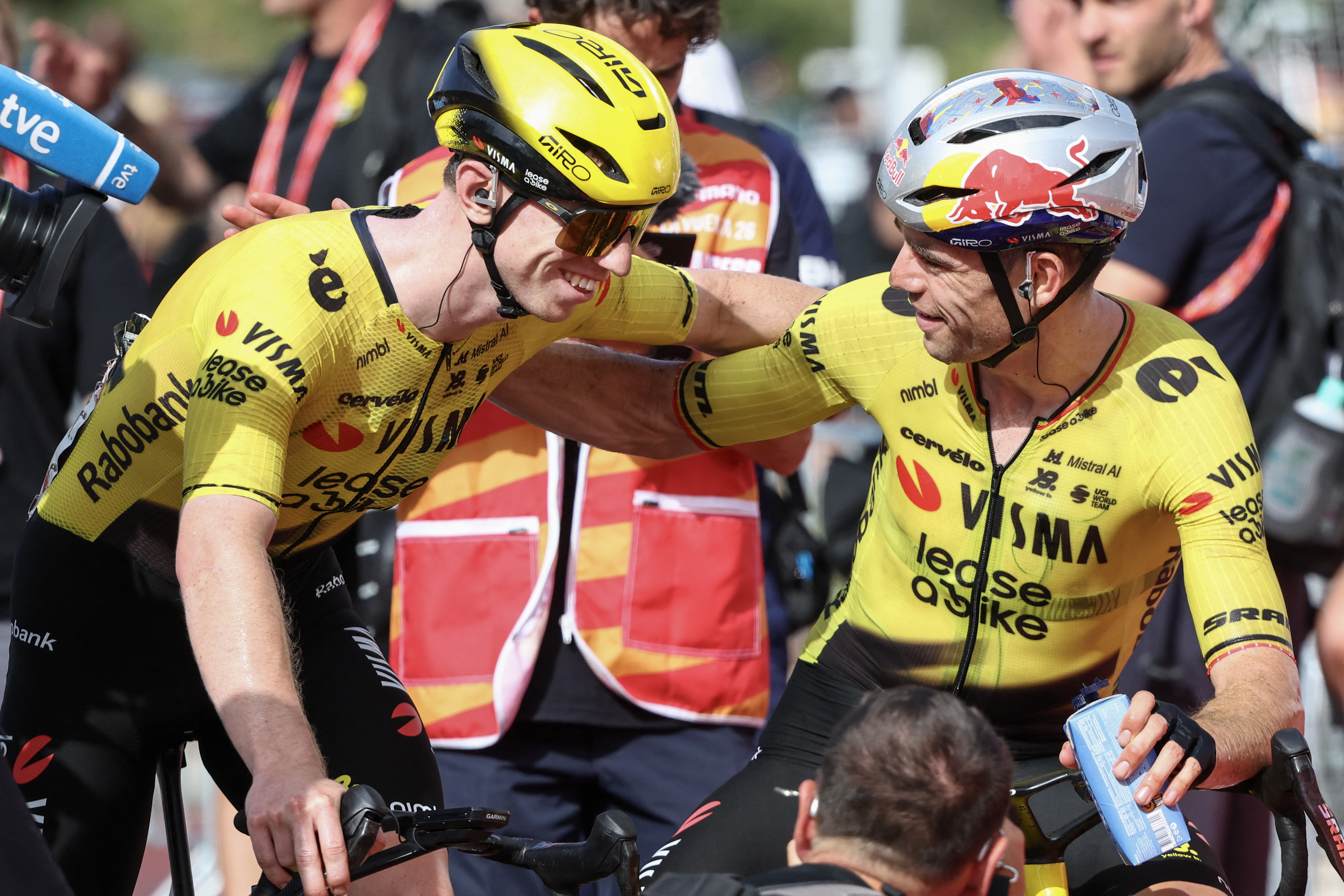 Team Visma-Lease a bike's British rider Matthew Brennan (L) is congratulated by teammate Wout van Aert after winning the fifth stage of the Vuelta a Espana 2026, a 173,4 km race between Falset and Roquetes on August 26, 2026. (Photo by Josep LAGO / AFP via Getty Images)