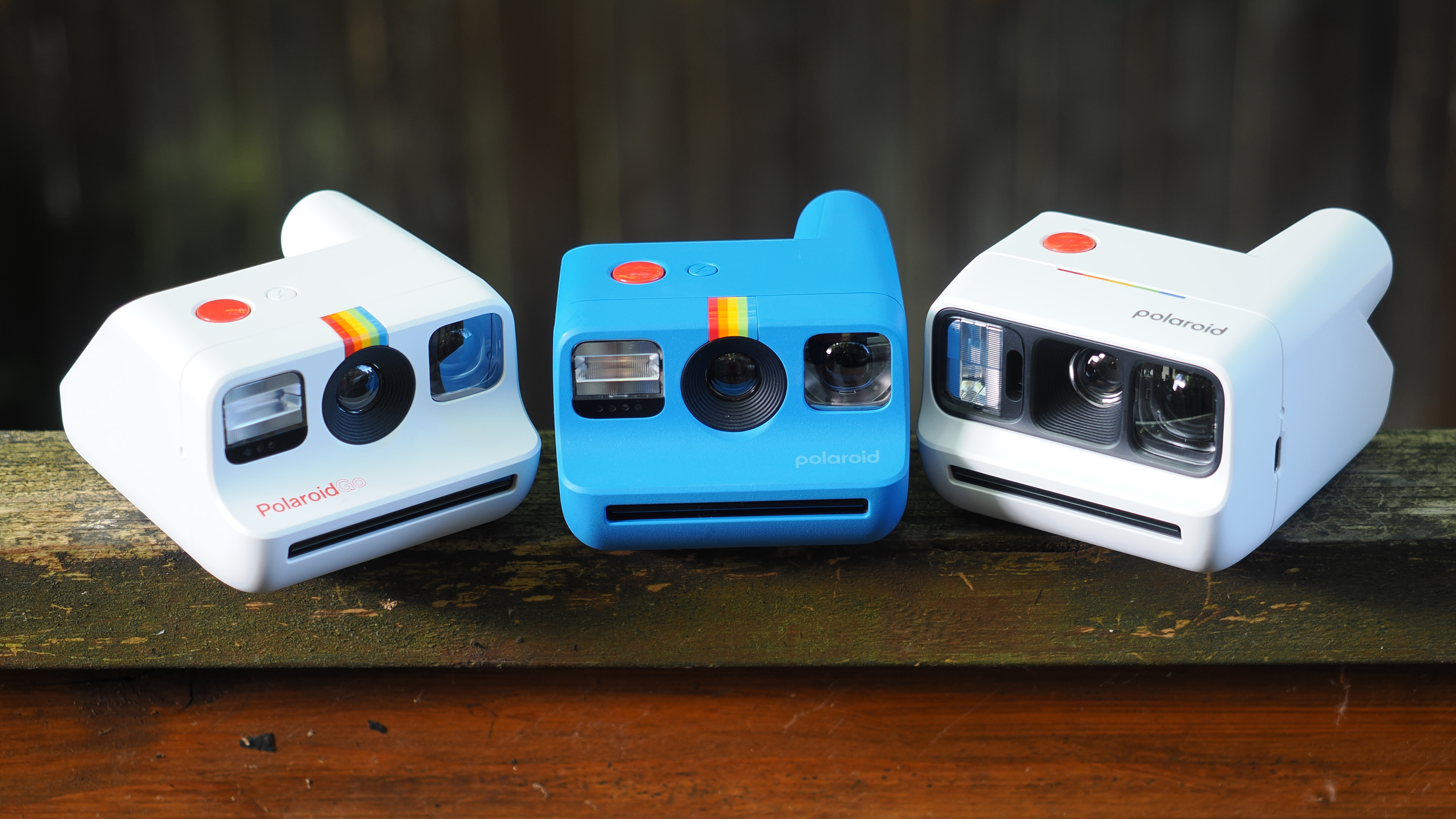 Polaroid Go, Gen 2 and Gen 3 on a wooden surface outdoors
