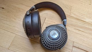 Focal Bathys wireless headphones on a wooden surface