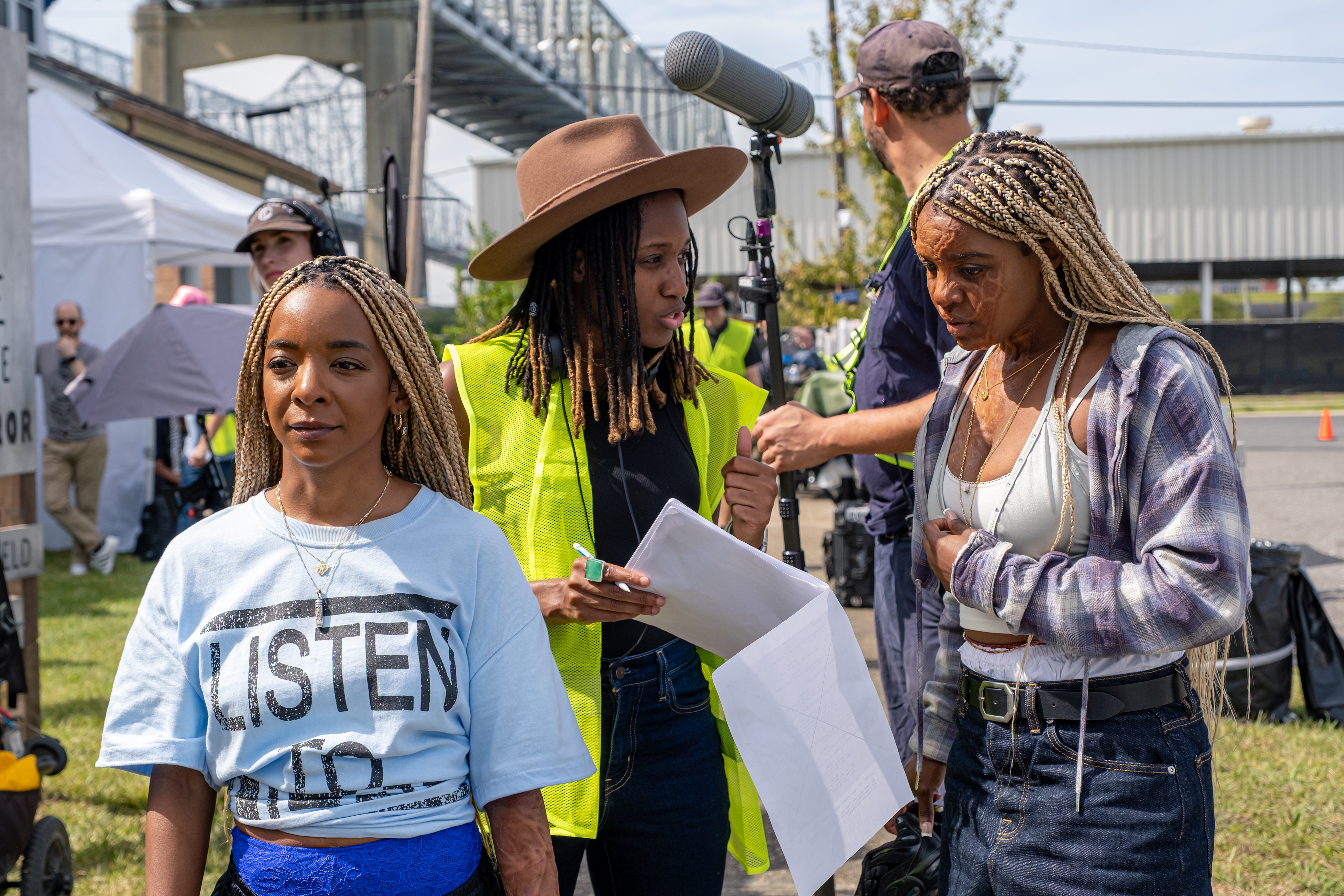 Actors Kara Young (left) and Mallori Johnson (right) speak with director Aleshea Harris (middle) on the set of 'Is God Is.'