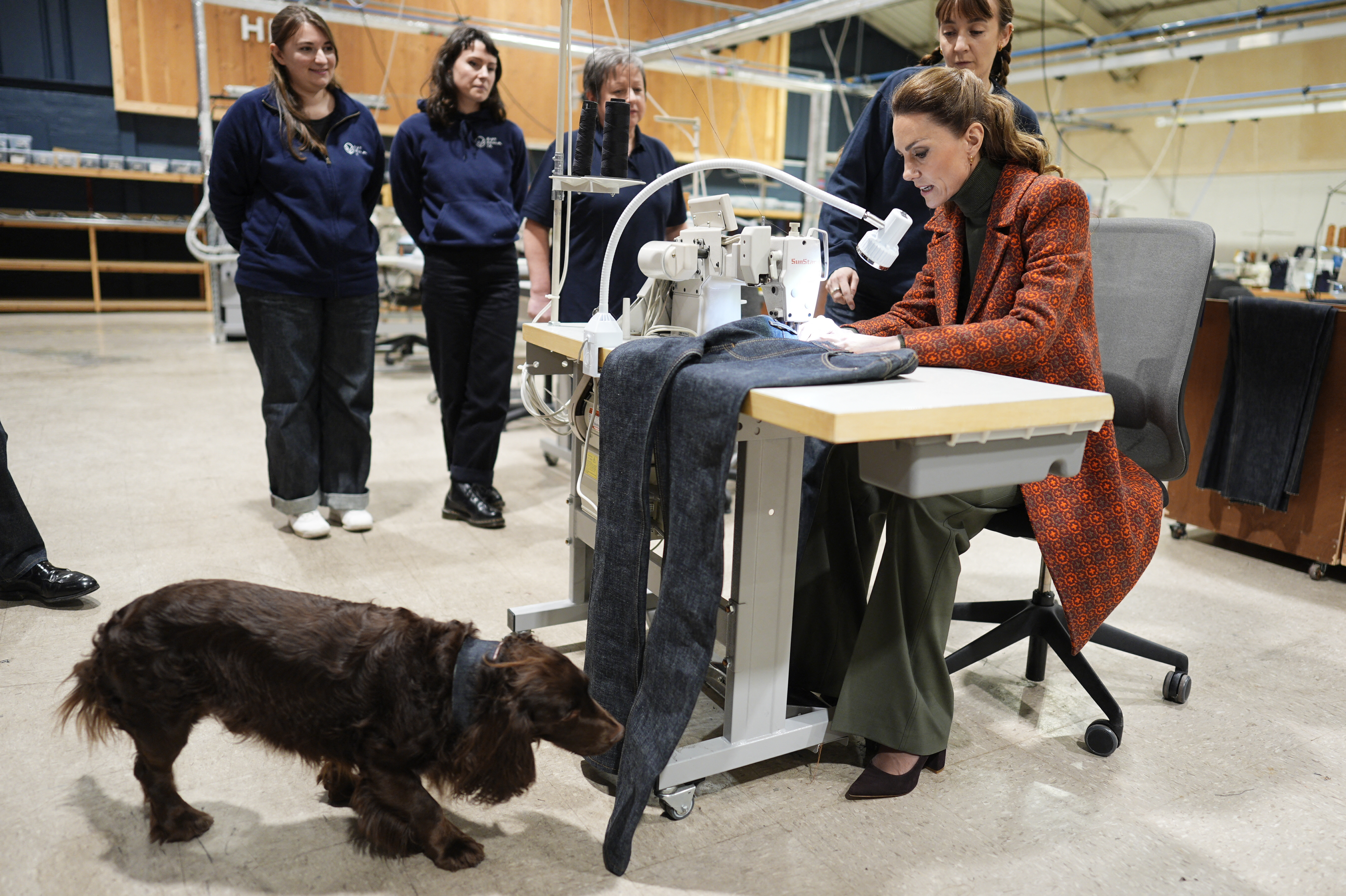 Britain's Catherine, Princess of Wales sews a 'Made in Wales' tag onto a pair of jeans during a visit to Hiut Denim, a family-owned company designing and manufacturing premium jeans in Cardigan, south-west Wales
