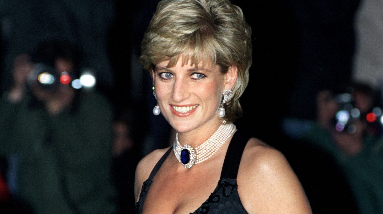 Princess Diana wears a pearl and sapphire choker and a black dress