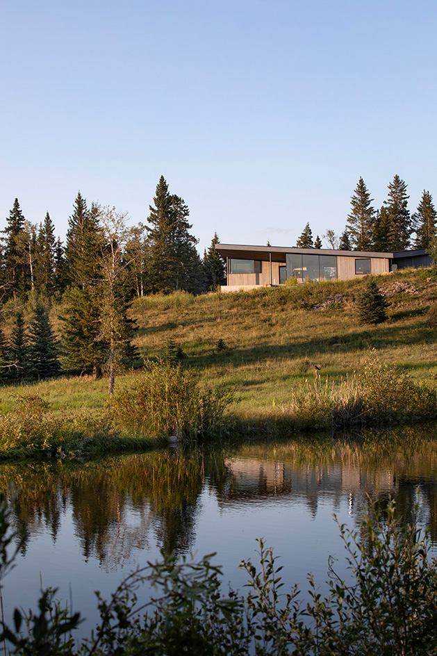Cut Out House, a square footprint home with a round cut out set in the canadian winderness, by a lake