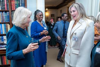 Camilla, Duchess of Cornwall and President of Women of the World Festival (L), meets actor Emerald Fennell (R), who portrayed the Duchess in the television series 'The Crown', during a reception to mark International Women's Day at Clarence House, in London, on March 8, 2022.