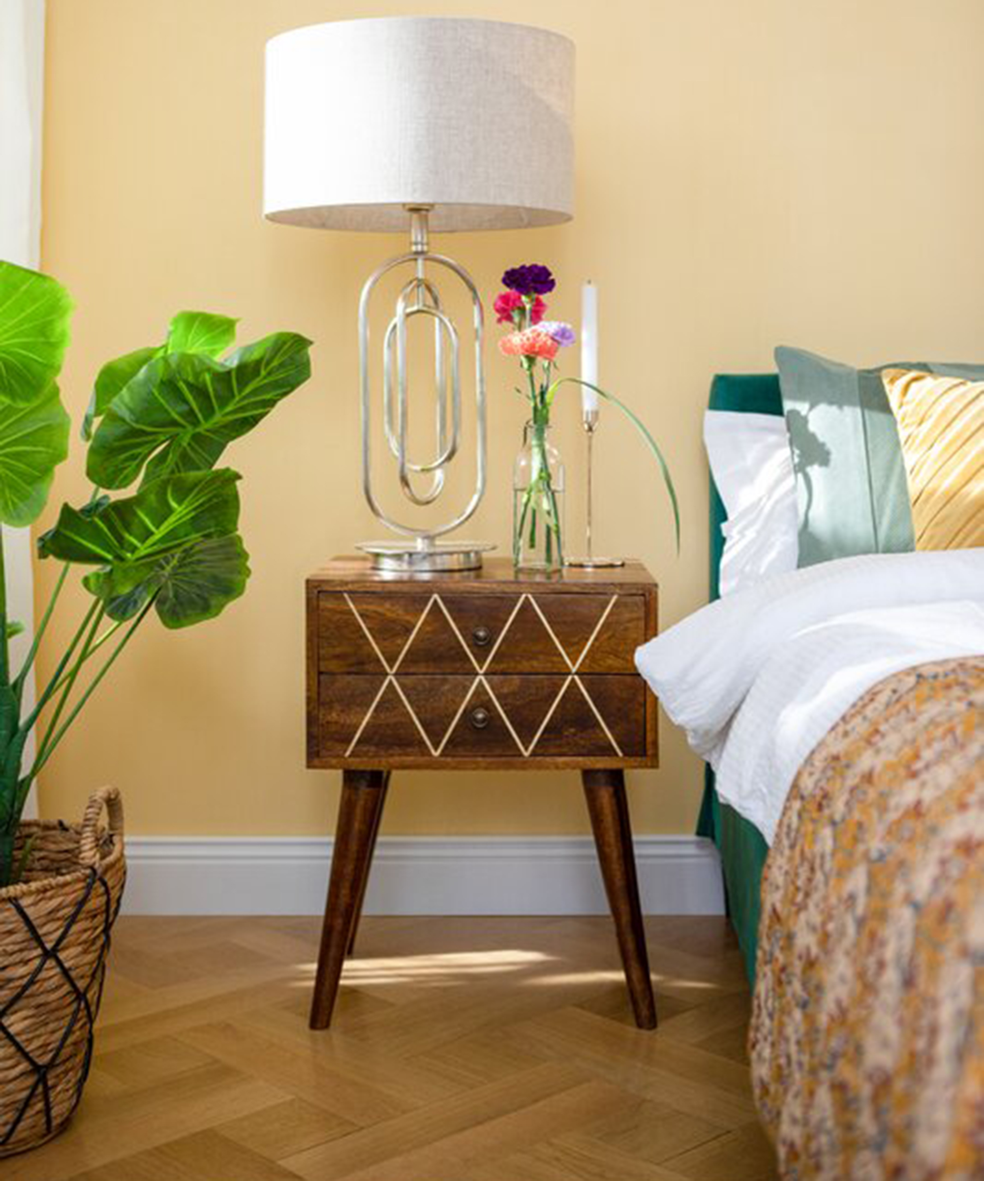 Yellow bedroom idea by Wayfair with bed and wooden drawers