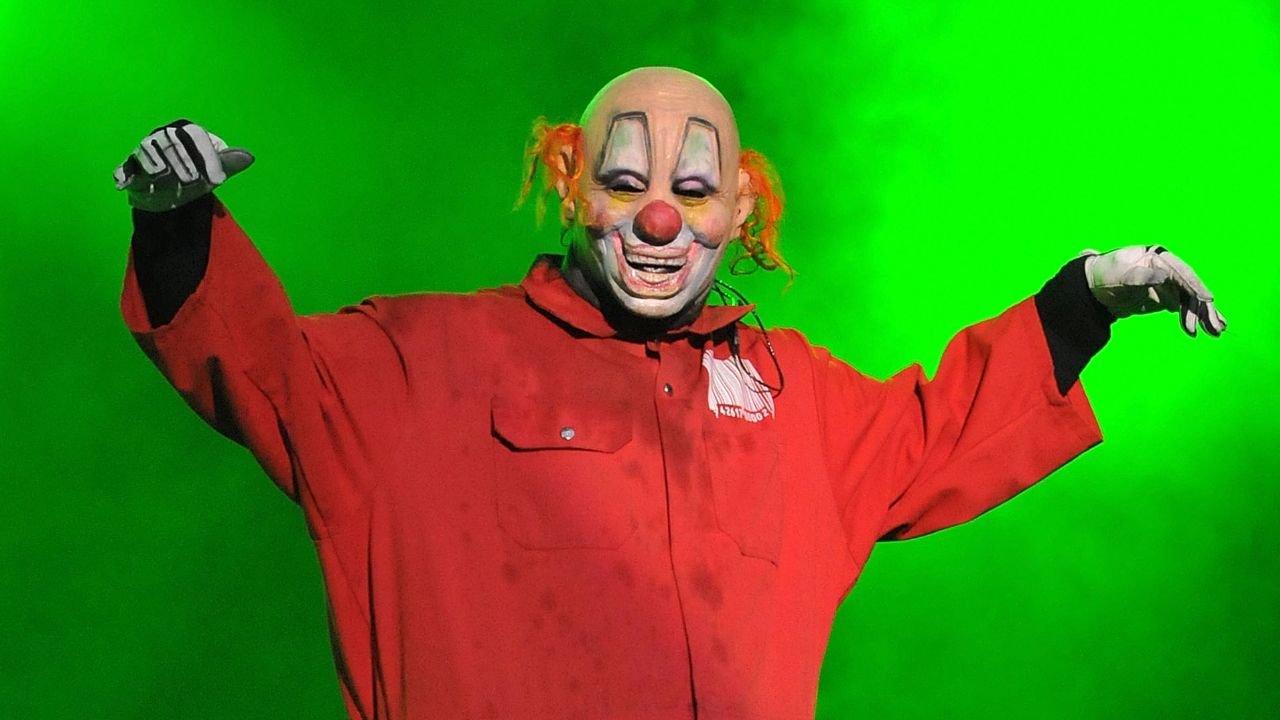 Clown on stage bathed in green light