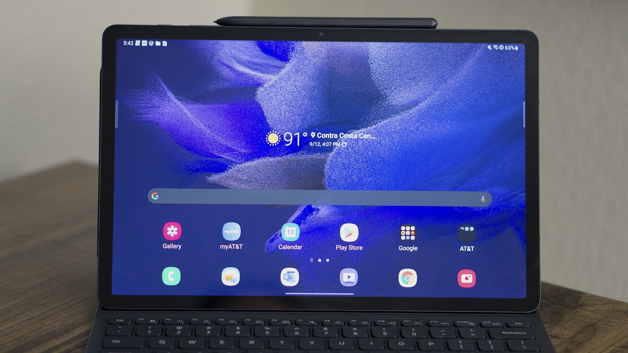 Samsung Galaxy Tab S7 FE home screen with keyboard and S Pen attached