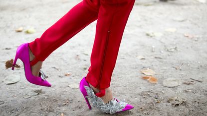 Red stirrup pants and pink high heels.