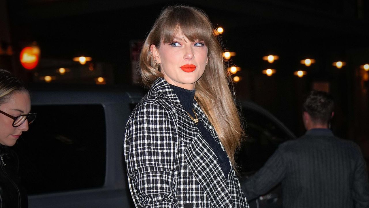 Taylor Swift wears coral lipstick with a checked jacket and matching blush