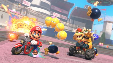 Mario Kart World screenshot showing Mario and Bowser on a race track in the Bob-omb mode.