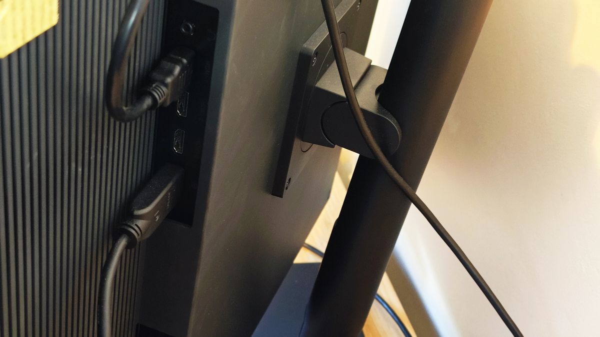 A black ASUS ProArt OLED PA32DC monitor sitting on a desk