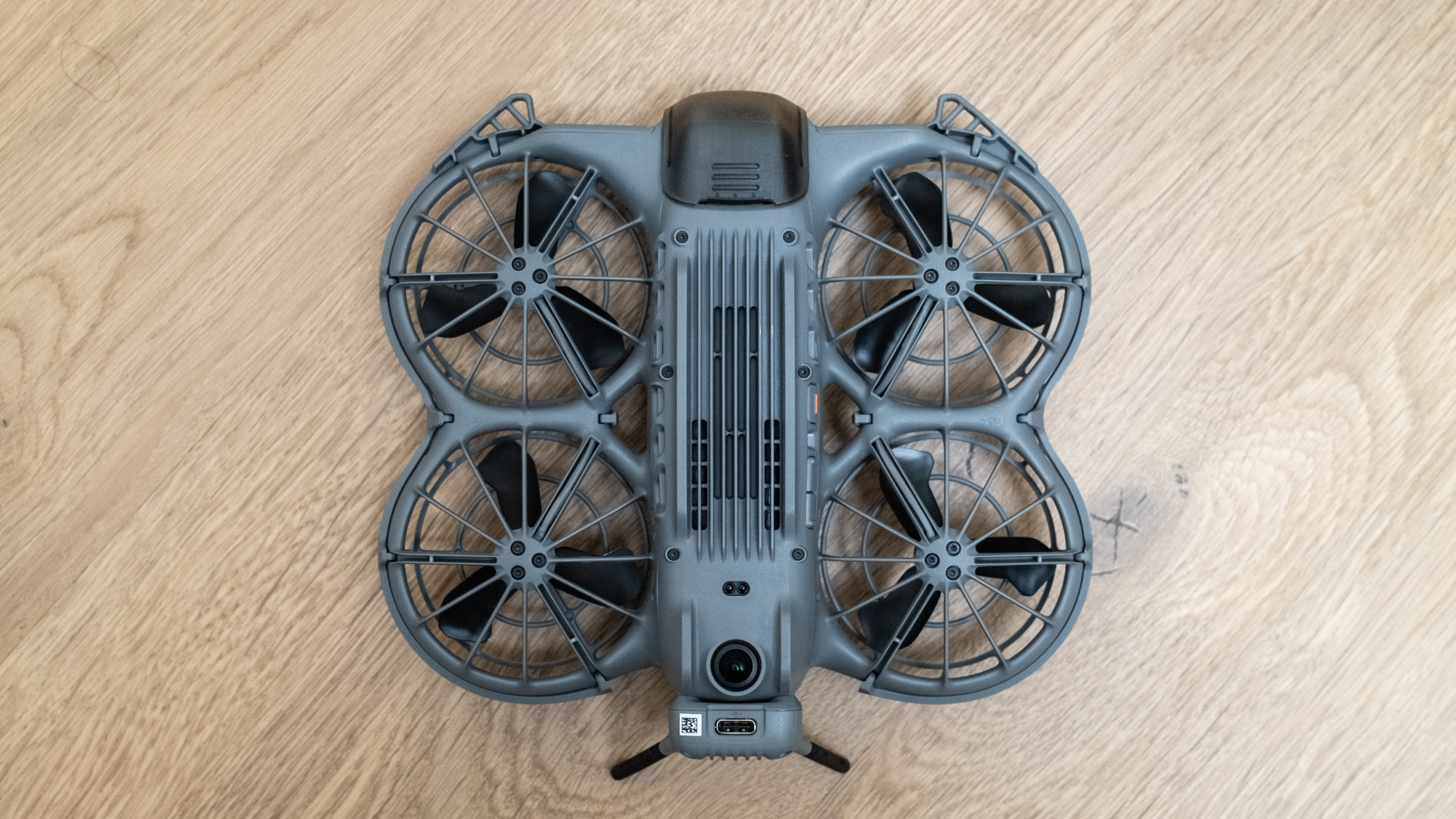DJI Neo 2 bottom view on a wooden floor