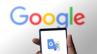 Google translate logo on a phone in front of a Google logo 