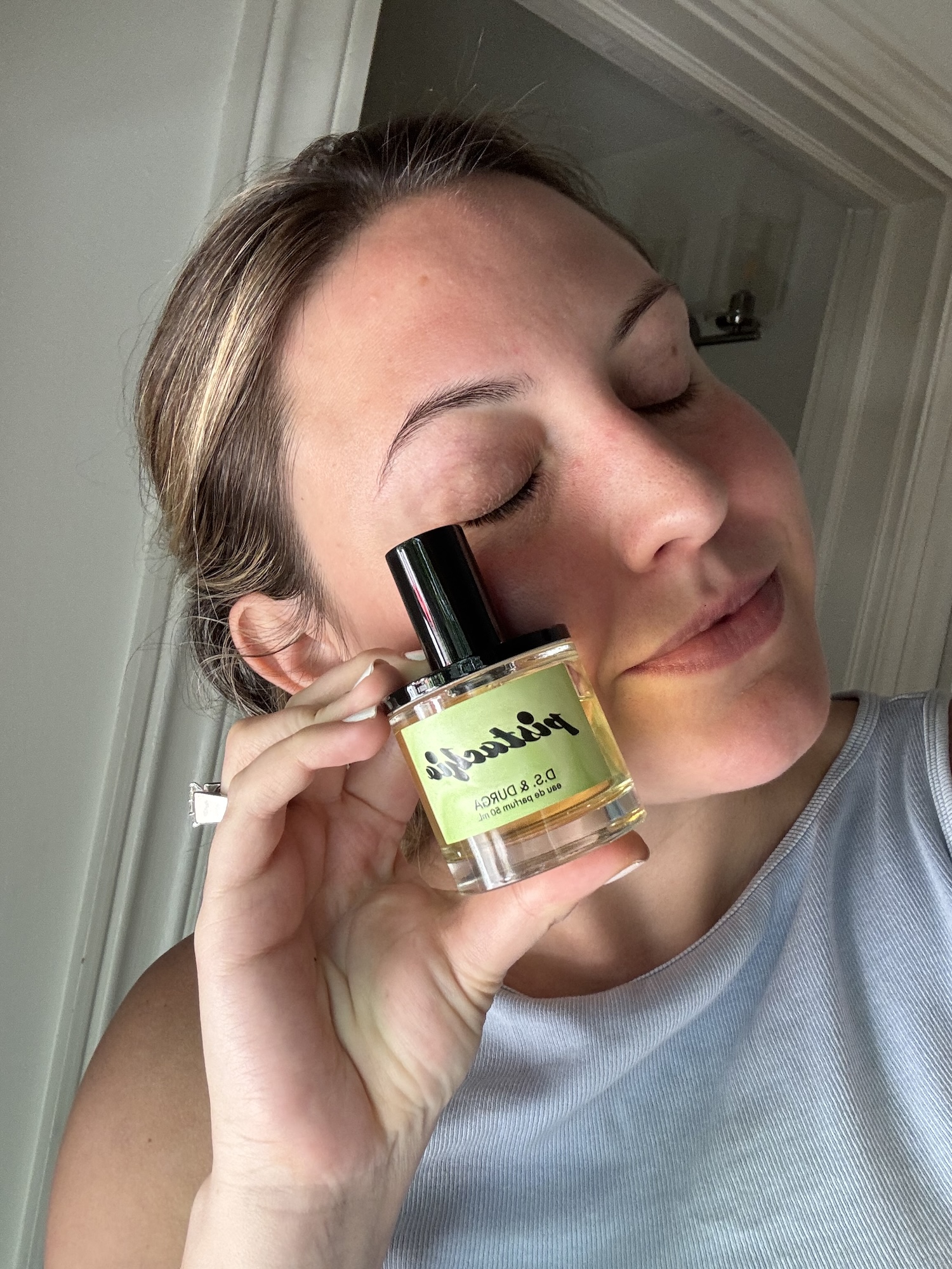 Sophia Vilensky poses with her bottle of D.S. & Durga Pistachio Eau de Parfum.