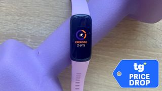 Fitbit Inspire 3 shown on purple dumbbell