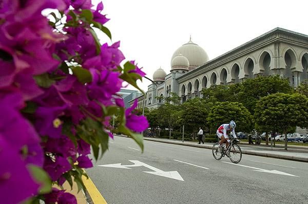 A rider makes his way along the streets of Putrajaya and pass one of the government buildings in the area