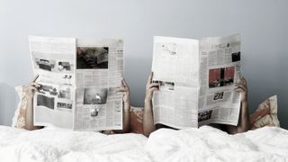 sexless marriage depicted by couple with newspapers