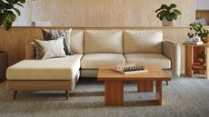 Neutral l-shaped sofa with matching sofa cover by wooden coffee table