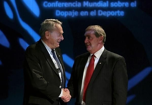Newly elected WADA president Australian John Fahey (left) shakes hands with outgoing president Dick Pound