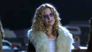 Kate Hudson in a fluffy white jacket and purple sunglasses in Almost Famous