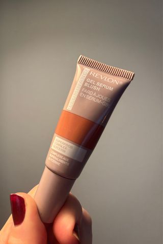 a hand holding revlon illuminance blusher