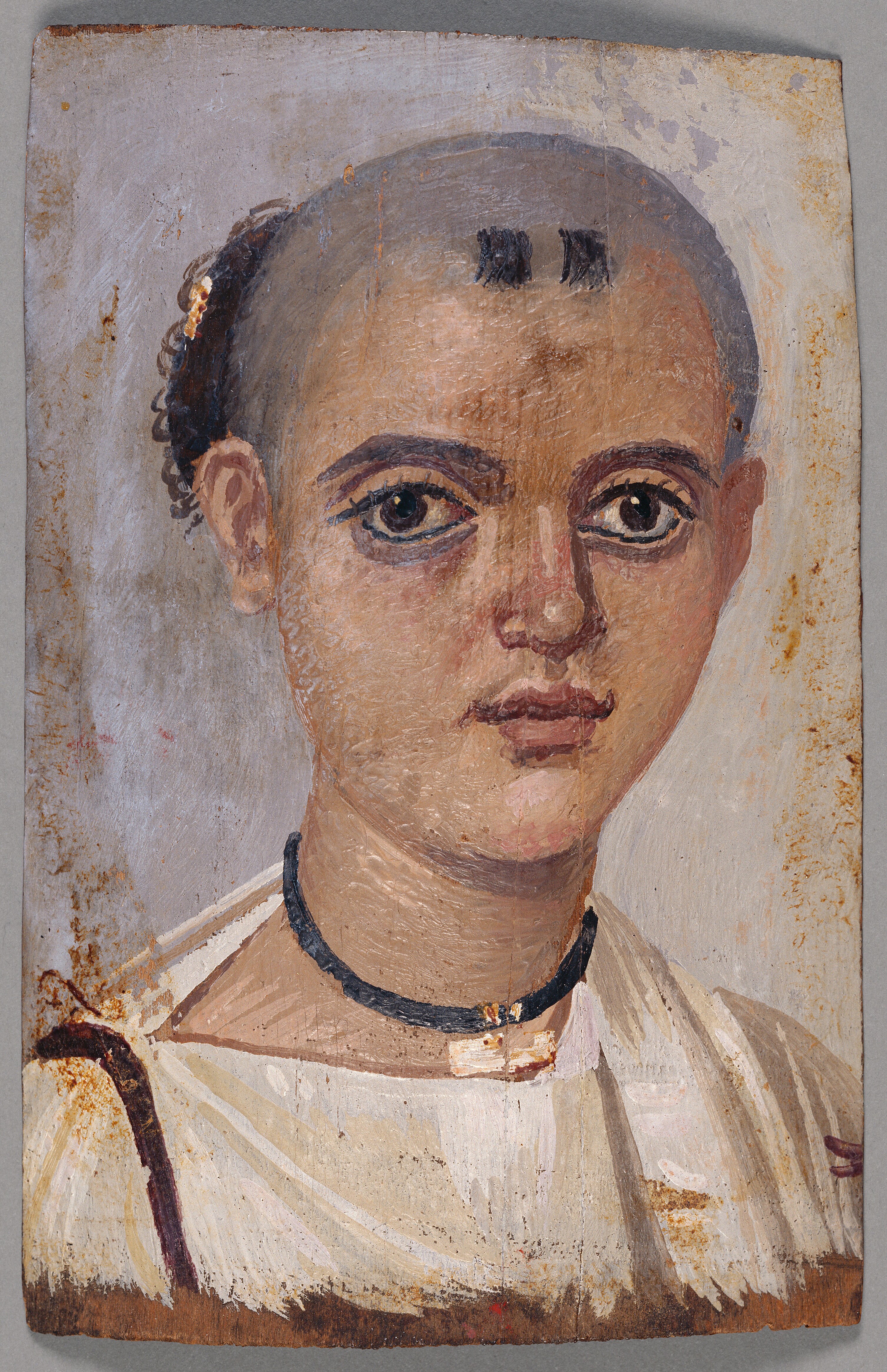 Mummy portrait of a youth wearing an amulet. Egyptian, 150&amp;ndash;200 CE. Encaustic onlinden wood, 8 &amp;times; 5 1/8 in. (20.3 &amp;times; 13 cm). The J. Paul Getty Museum, Villa Collection,78.AP.262