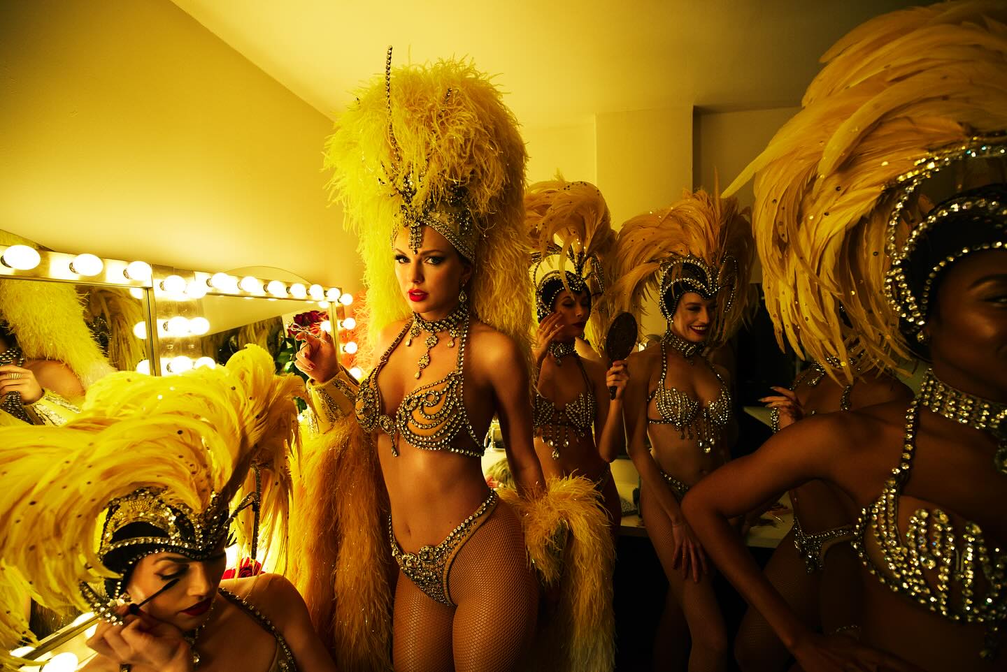 Taylor Swift and her dancers wearing Bob Mackie diamond outfits in a backstage setting