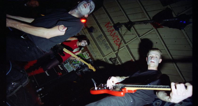 Ink &amp; Dagger perform in makeup in a suitably punk looking venue with spray-painted walls.